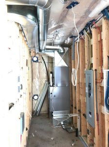 Furnace neatly installed with custom return air base and filter frame.